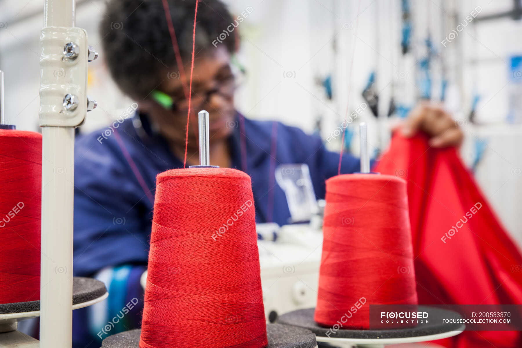 Seamstress working on overlocker in factory, Cape Town, South Africa