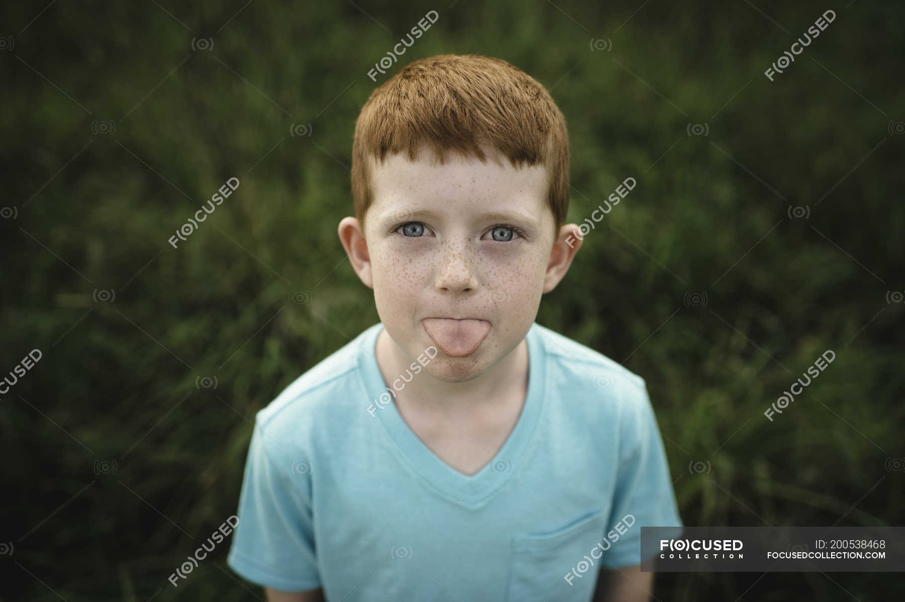 portrait-of-red-haired-boy-sticking-out-tongue-lifestyle-leisure