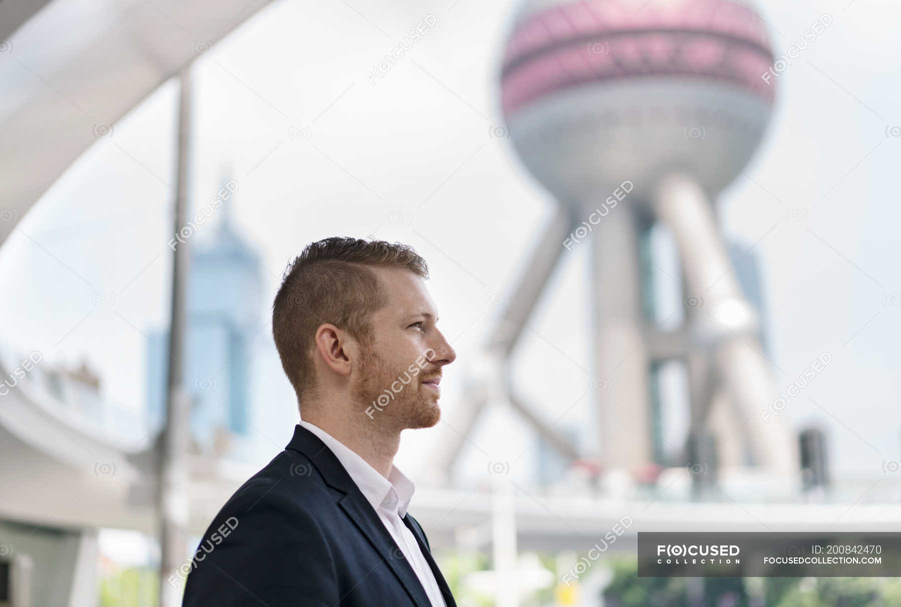 Young businessman looking away at Shanghai financial center, China — 25 ...