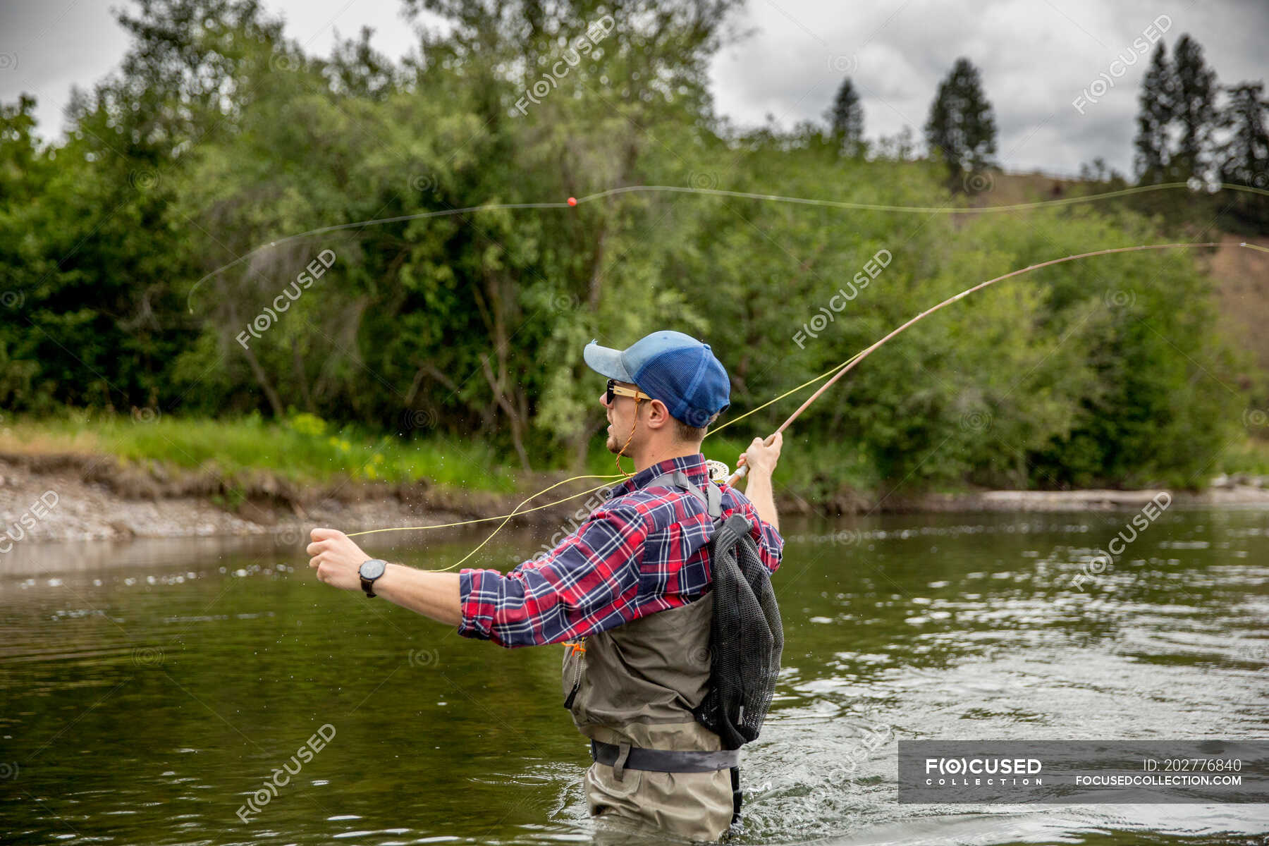 Man fishing in river, Clark Fork, Montana and Idaho, US — Focus On