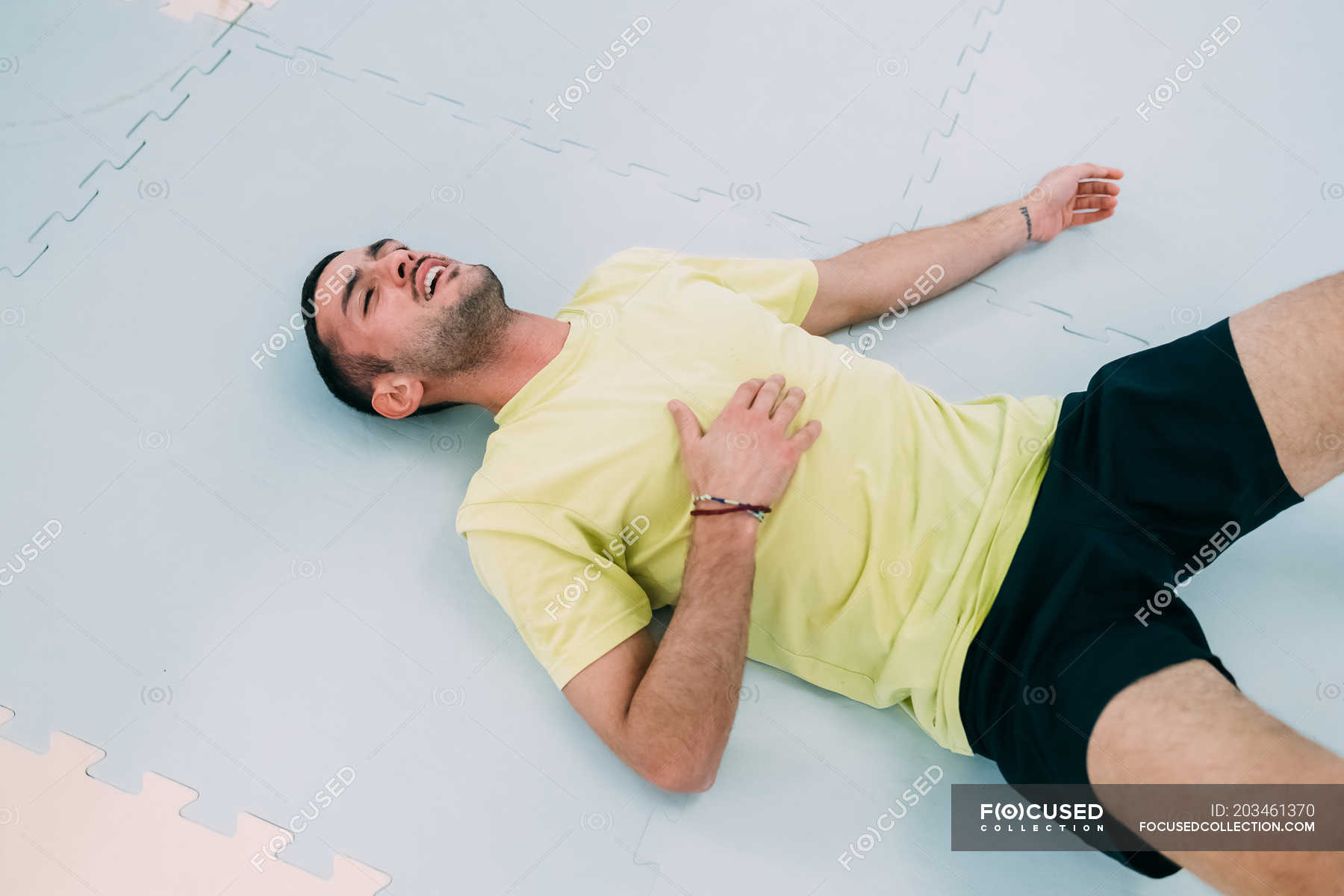 Exhausted man lying on floor on back — sport, male Stock Photo 203461370