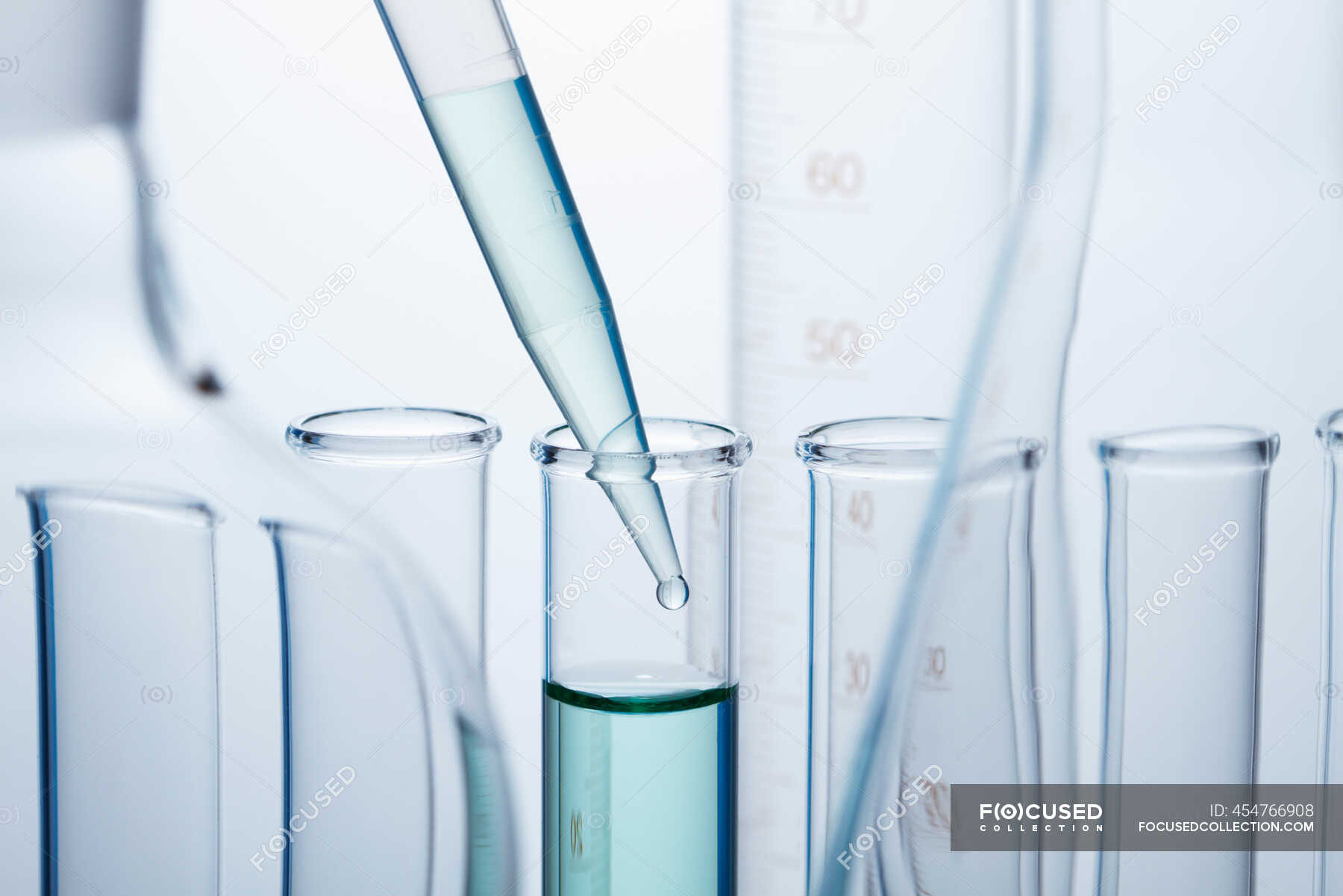 A precision micropipette is used to transfer a small amount of l