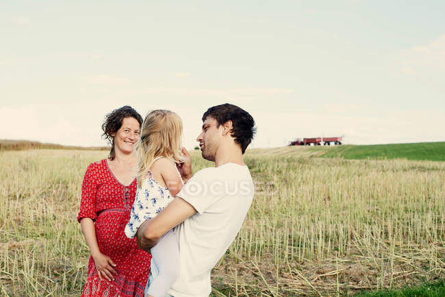 Pregnant couple with daughter — Stock Photo