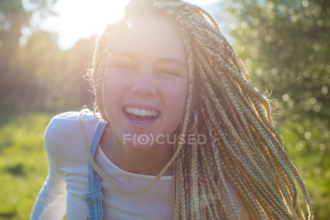 Woman with long plaited blond hair in field — Stock Photo