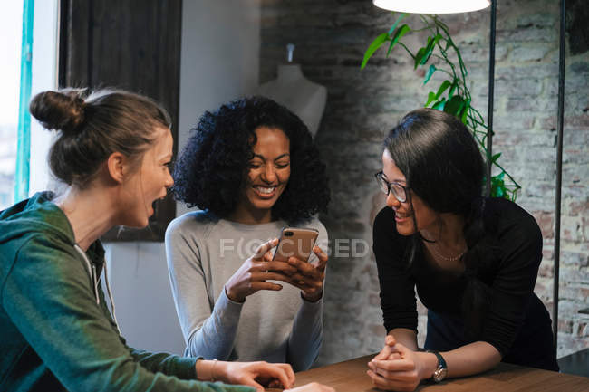 Friends looking at mobile phone — Stock Photo