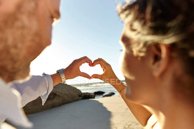 Mature couple making heart shape — Stock Photo
