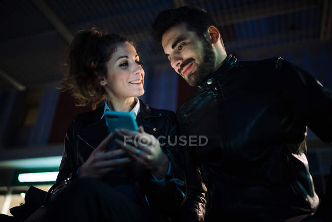 Couple using mobile phone — Stock Photo
