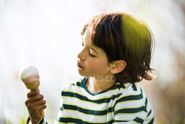 Boy gazing at ice cream cone — Stock Photo