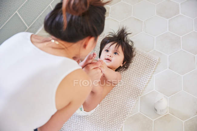 Woman playing with daughters feet — Stock Photo