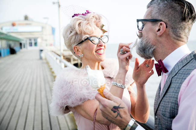 Woman wiping boyfriends beard on pier — Stock Photo