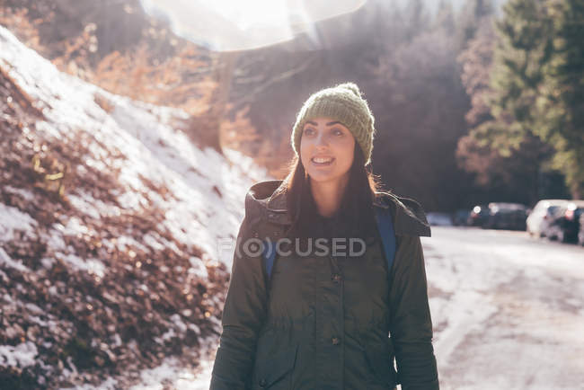 Female hiker hiking along forest road — Stock Photo