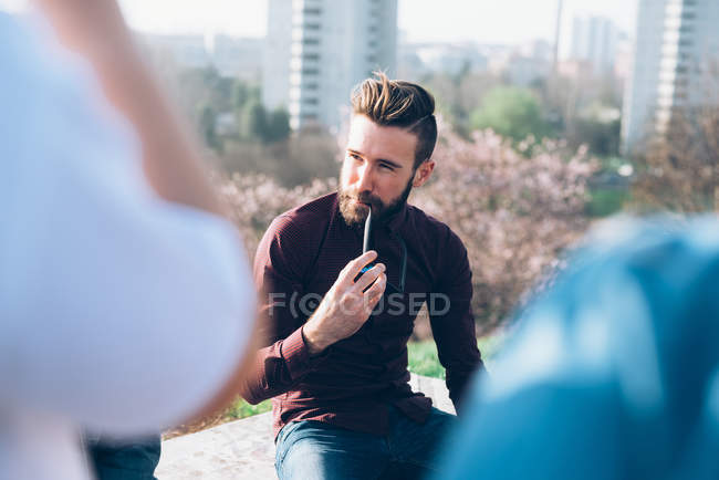 Young man relaxing at roof party — Stock Photo