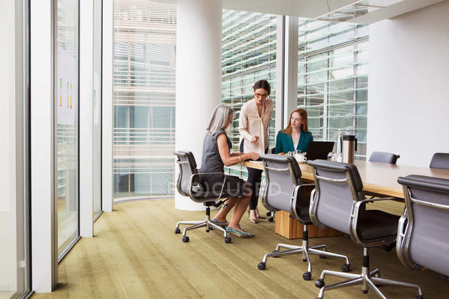 Businesswomen preparing presentation in meeting room — Stock Photo