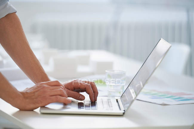 Cropped view of man using laptop — Stock Photo