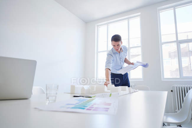 Architect in office with blueprint — Stock Photo