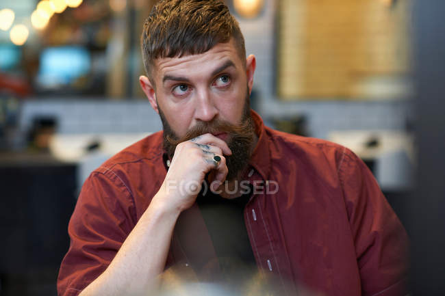 Portrait of tattooed bearded man — Stock Photo