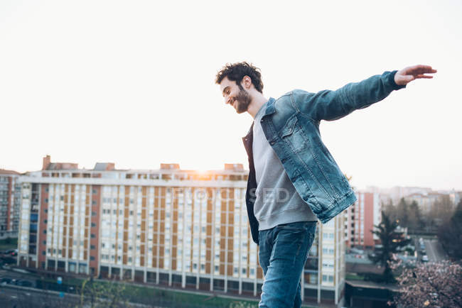 Young man walking on rooftop — Stock Photo