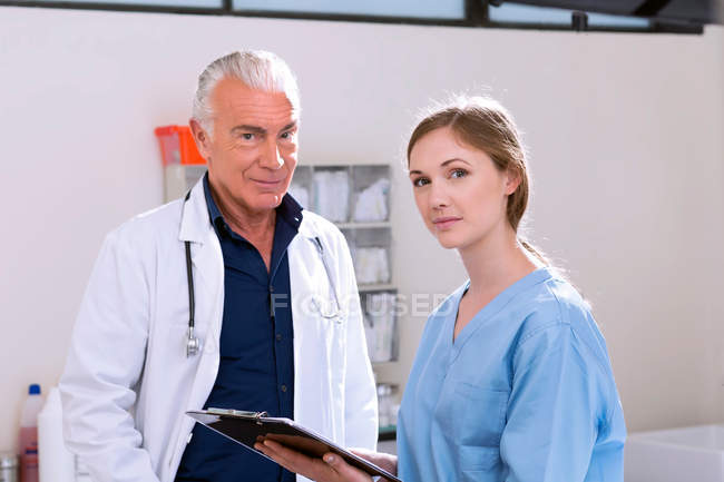 Doctors in clinic looking at camera — Stock Photo