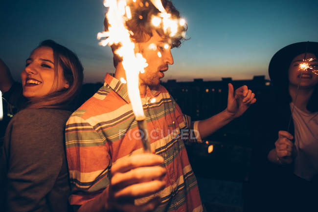 Group of friends enjoying roof party — Stock Photo