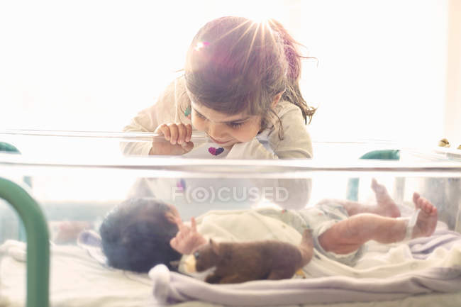 Girl looking at newborn baby — Stock Photo