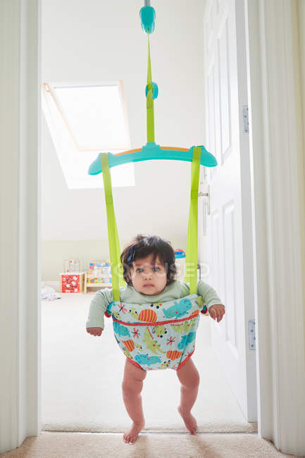 Bebê menina olhando a partir de bebê bouncer — Fotografia de Stock
