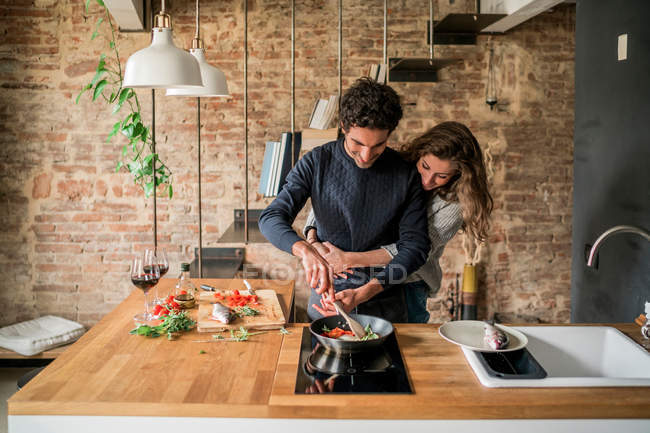 Couple cooking fish cuisine at kitchen — Stock Photo