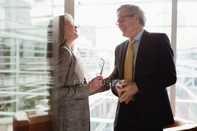 Businessman and businesswoman in coffee area in office — Stock Photo