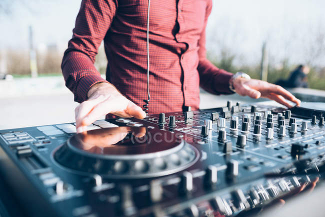 Young man using mixing desk — Stock Photo