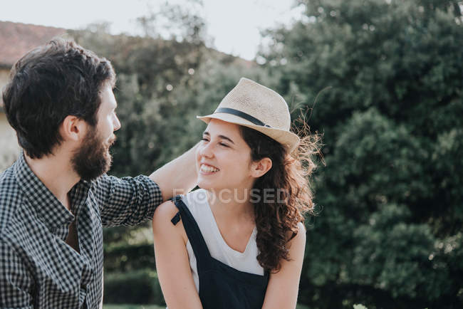 Man trying trilby hat on girlfriend — Stock Photo