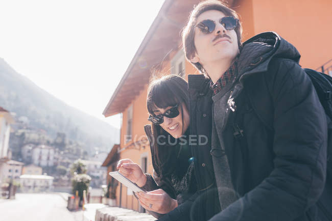Couple using smartphone touchscreen — Stock Photo