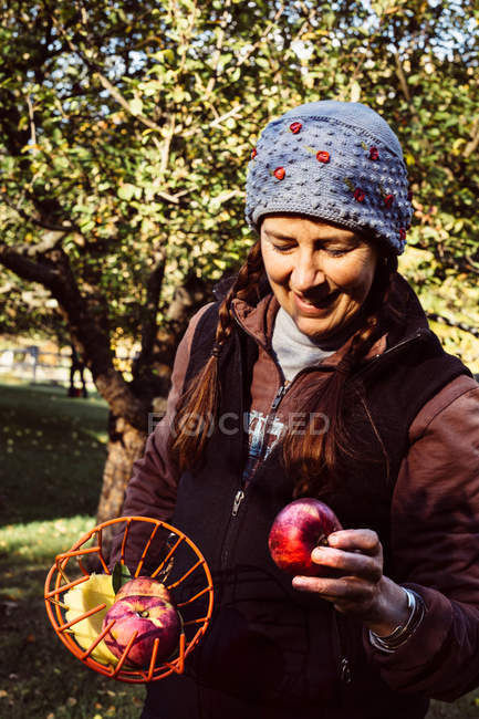 Woman holding fruit picker — Stock Photo