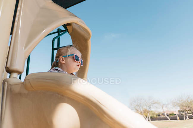 Girl on playground slide — Stock Photo