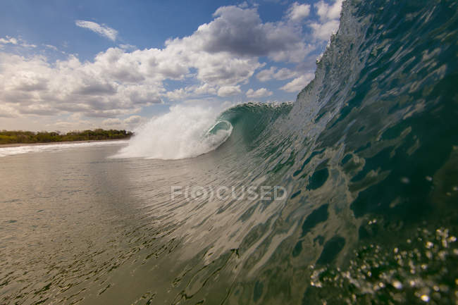 Rolling wave and beach — Stock Photo