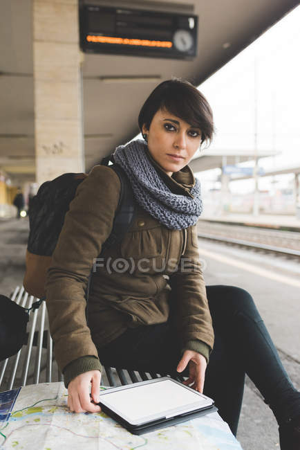 Portrait of female backpacker with map — Stock Photo