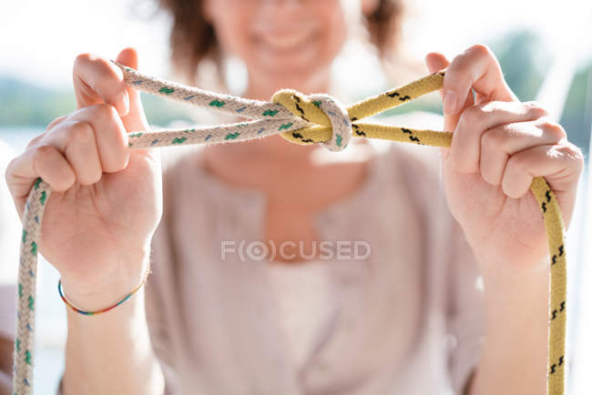 Woman showing nautical knot — Stock Photo