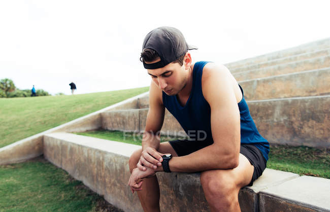 Man looking at activity tracker — Stock Photo