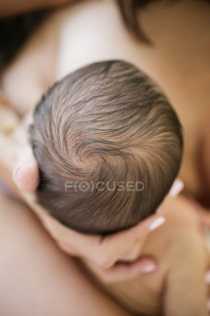 Mother holding newborn baby boy — Stock Photo