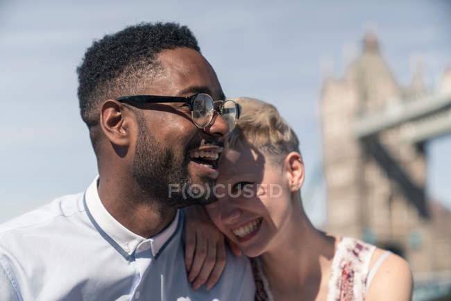 Young couple laughing together outdoors — Stock Photo