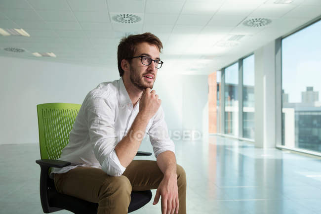 Businessman sitting in chair — Stock Photo