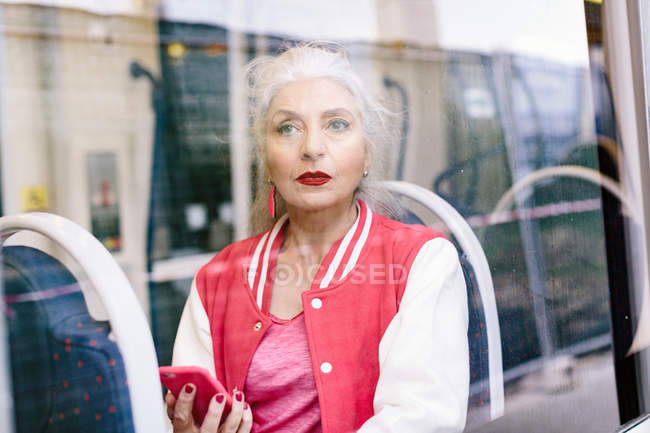 Зрелая женщина в бейсбольной куртке — стоковое фото