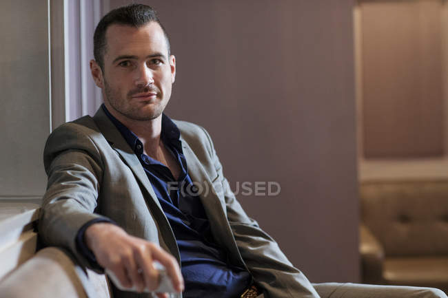 Businessman taking break on couch — Stock Photo