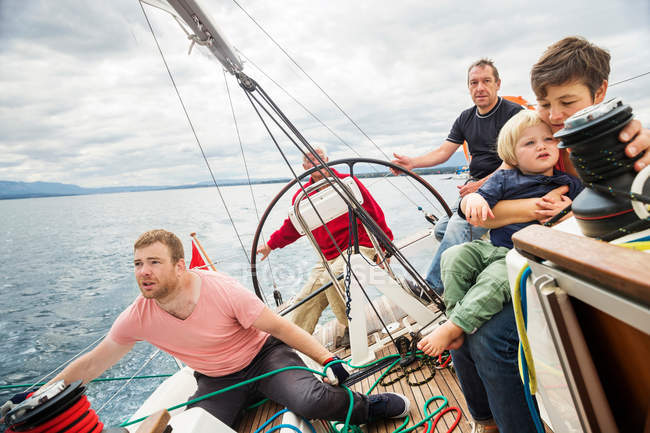 Four generation family on sailing boat — Stock Photo