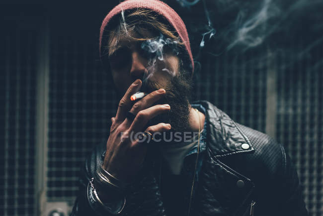 Hipster smoking cigarette — Stock Photo