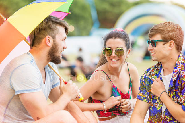 Friends at festival chatting — Stock Photo