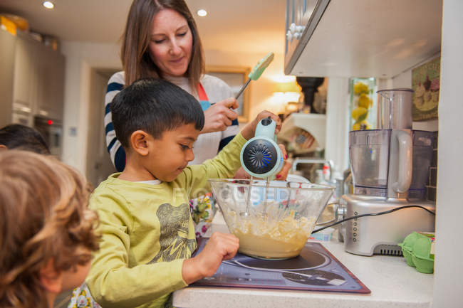Childminder and children baking — Stock Photo