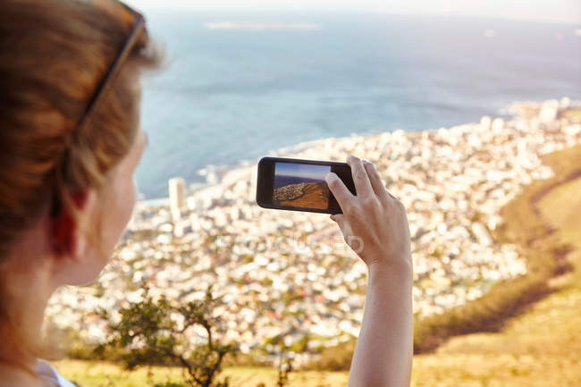 Woman on mountain, photographing view — Stock Photo
