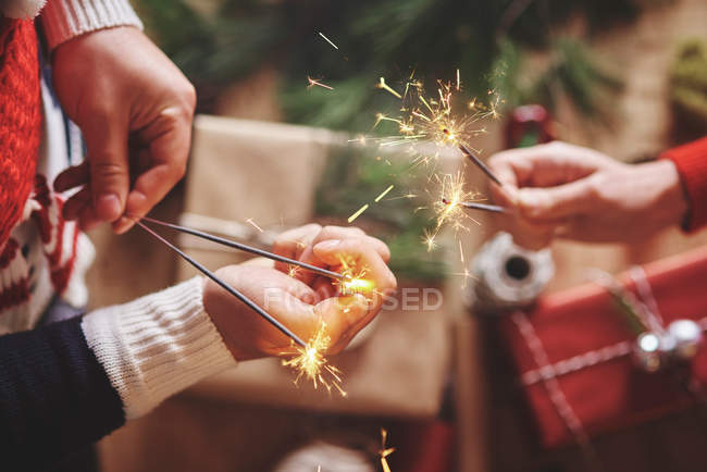 Couple holding indoor sparklers — Stock Photo