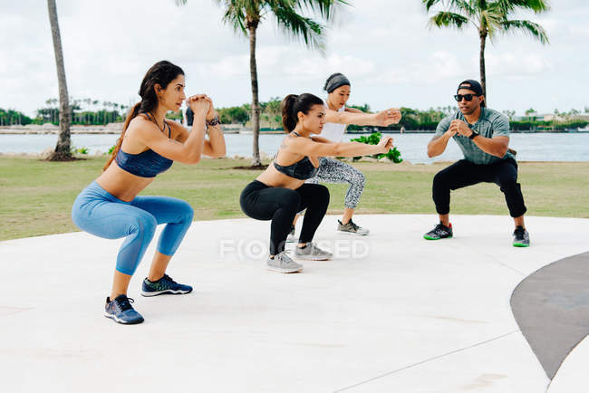 Women working out with trainer — Stock Photo