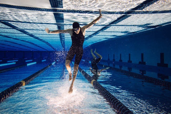 Nadadores bajo el agua en la piscina - foto de stock