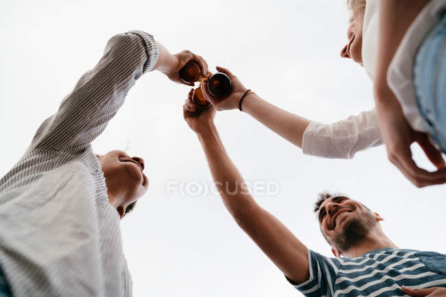 Friends holding bottles of beer — Stock Photo
